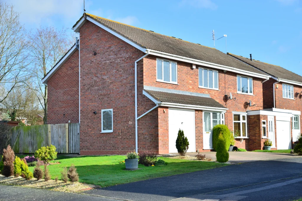 A brand new tarmac driveway installed onto a residential uk red brick house